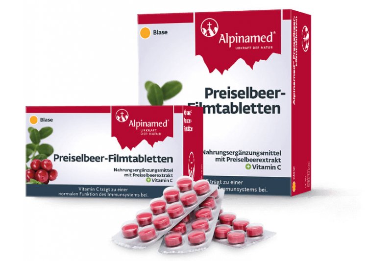 Ein Paket Preiselbeer-Filmtabletten mit rotem Verpackungsdesign, das die Inhaltsstoffe und Anwendung zeigt.
