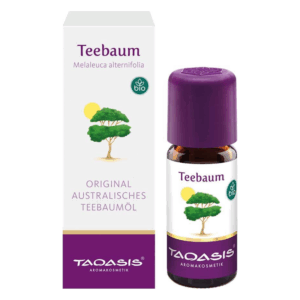 Flasche mit Teebaumöl und umgebender Verpackung, die das Produkt und seinen bio-zertifizierten Ursprung beschreibt.