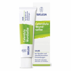 Weleda Calendula Wundsalbe in einer Tube mit grünem und weißem Etikett, neben der Produktverpackung.
