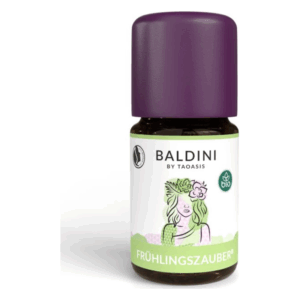 Braune Glasflasche mit lila Kappe und Etikett, das "FRÜHLINGSZAUBER®" und eine weibliche Figur mit Blumen zeigt.