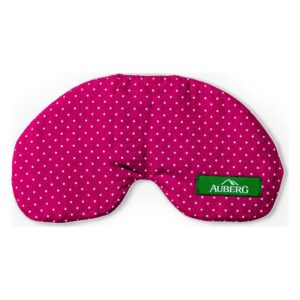 Rosafarbene Schlafmaske mit weißen Punkten und grünem Etikett mit der Aufschrift 'Auberg'