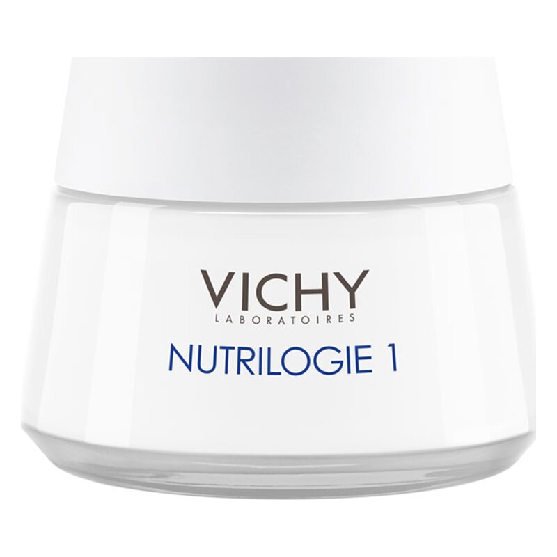 Eine weiße Creme in einem Glasbehälter mit einem grauen Deckel, gekennzeichnet mit "VICHY NUTRILOGIE 1".