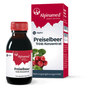 Flasche mit Preiselbeer-Trinkkonzentrat, verpackt in einer rot-weißen Box, als Nahrungsergänzungsmittel.