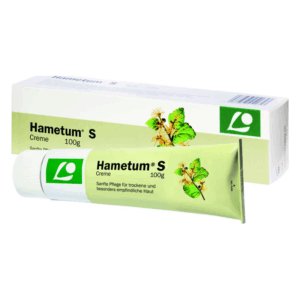 Tube Hametum S Creme für trockene und empfindliche Haut, umgeben von einer Verpackung mit Pflanzenmotiven.