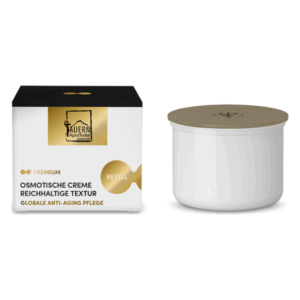 Verpackung einer osmotischen Creme mit reichhaltiger Textur in einer weißen Dose und schwarzem Karton mit goldenen Akzenten.