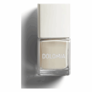 Nagellack in transparenter Flasche mit weißen Deckel, Marke DOLМIA, in einem hellen Beigeton.