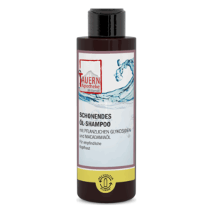 Flasche mit schützendem Öl-Shampoo für empfindliche Kopfhaut, mit pflanzlichen Glykosiden und Macadamiaöl.