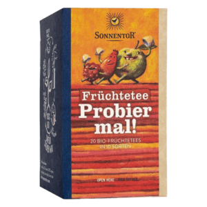 Verpackung für Früchtetee von Sonnentor mit bunten Früchte-Cartoonfiguren und dem Text "Probiere mal!".