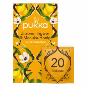 Verpackung von Pukka Bio-Kräutertee mit Zitrone, Ingwer und Manuka-Honig in leuchtend gelber Box und Teebeutel.