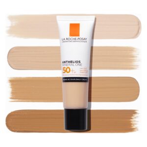 Tube von La Roche-Posay Anthelios Mineral One Sonnencreme SPF 50+ vor verschiedenen Farbtönen der Creme.