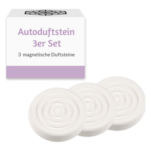 Drei weiße, runde magnetische Duftsteine, verpackt in einer lilafarbenen Schachtel mit dem Aufdruck "Autoduftstein 3er Set".