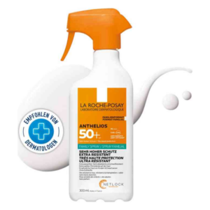 Sonnencreme in einer weißen Sprühflasche mit orangefarbenem Sprühkopf, hoher Lichtschutzfaktor 50+, dermatologisch empfohlen.