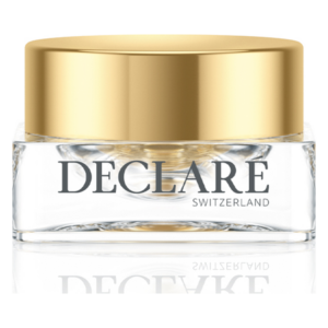 Eine Glastiegel mit goldener Kappe, beschriftet mit "DECLARE SWITZERLAND" und einem klaren Inhalt.
