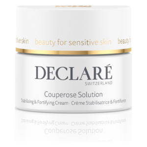 Glänzender Behälter mit einer stabilisierenden Creme für empfindliche Haut, beschriftet mit "Couperose Solution" und goldener Akzentlinie.
